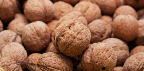Brown raw walnuts textured background