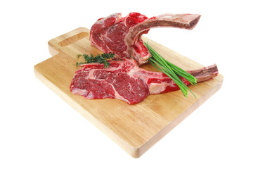 raw pork with thyme and green chives on wooden board