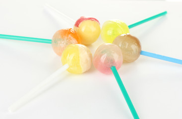 Many delicious lollipops on white background