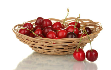cherry in wicker bowl isolated on white