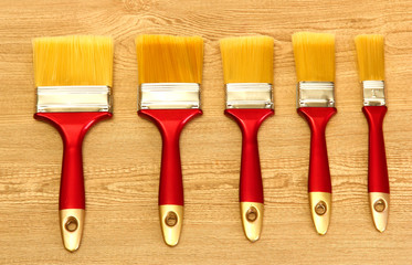 paint brushes on wooden background