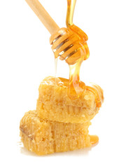 golden honeycombs and wooden drizzler with honey isolated