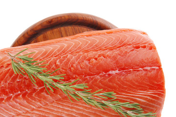 fresh uncooked salmon fillet on wooden plate