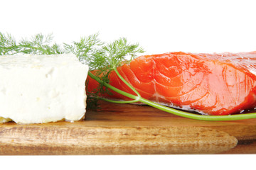 smoked salmon on wooden plate with white cheese