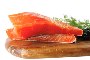 smoked salmon on wooden plate with white cheese