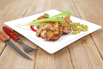 roasted chicken legs garnished with pepper