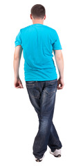 Back view of young men in  blue t-shirt and jeans.