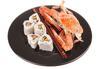 Maki Rolls and California rolls on black with prepared crab