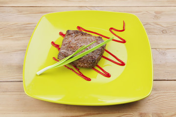 meat food : roasted fillet mignon on green plate with chives