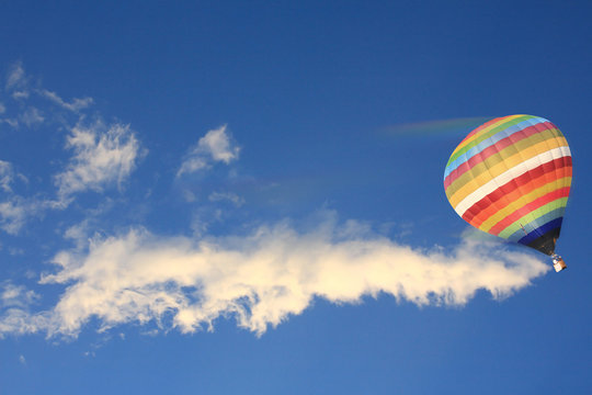 high speed hot air balloon on blue sky.