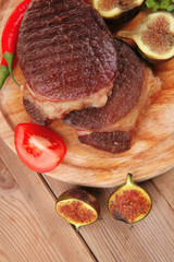 grilled beefsteak served with hot cayenne peppers green stuff