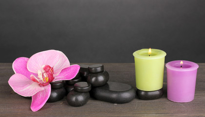Fototapeta na wymiar Spa stones with orchid flower and candles