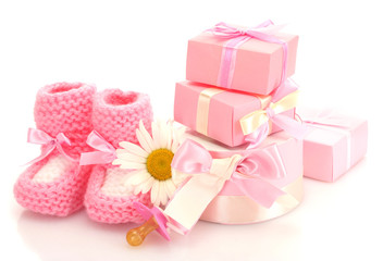 pink baby boots, pacifier, gifts and flower isolated on white