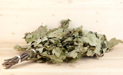 Bath broom of oak on wooden background