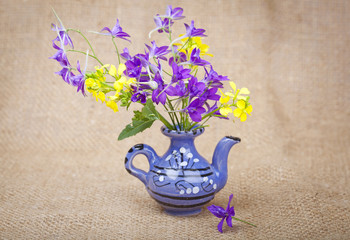 Bouquet of flowers in a ceramic teapot