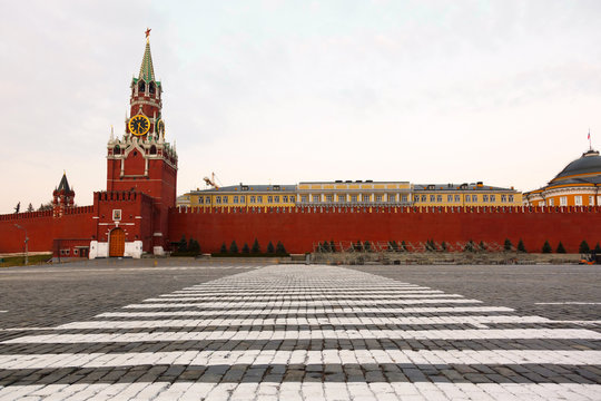 crosswalk at an empty Red Square and the Spassky tower 