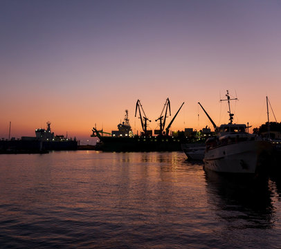 Silhouettes of ships in port