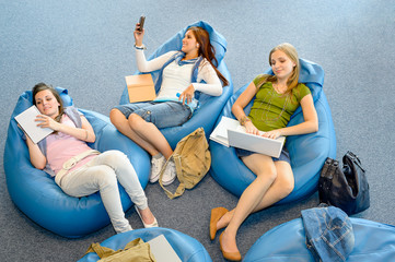 Group of students lying on beanbag relax