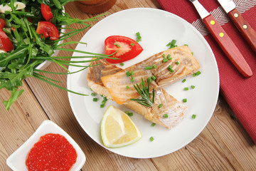  grilled pink salmon steaks with red caviar in white bowl