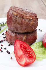 grilled beef fillet medallions with thyme on wood