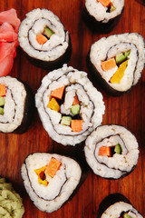 sushi rolls on wood with wasabi and ginger