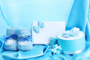 beautiful gifts, baby's bootees, blank postcard and dummy