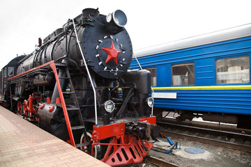 Naklejka premium Old steam train is leaving a station