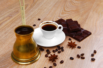 black coffee in small white cup with beans