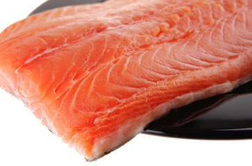 fresh uncooked red fish fillet on black