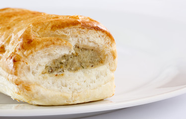 Sausage roll on a white plate