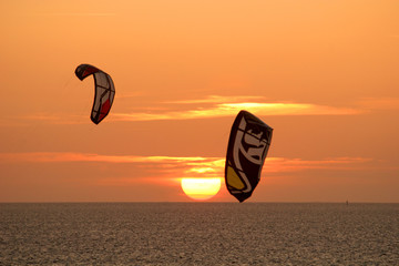 kitesurfers at sunset