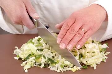 female chef prepares a savoy cabbage