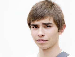 Portrait of the young man on a light background