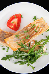 salmon steaks garnished with tomatoes