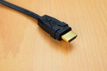 Hdmi gold connector cable close up on wooden background