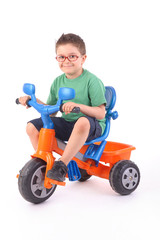 young boy riding his tricycle