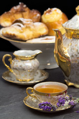 lavender flavored tea with teapot and sweets