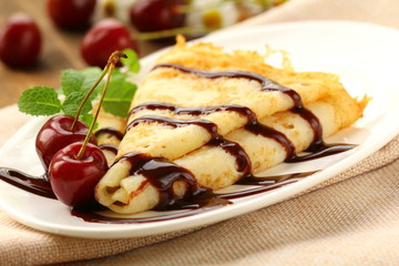 Sweet pancake with chocolate sauce and cherries - obrazy, fototapety, plakaty