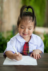 Little girl write on paper