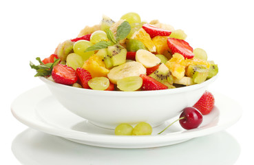bowl with fresh fruits salad and berries isolated on white