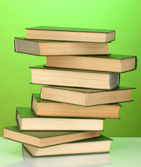 Tower of books on green background