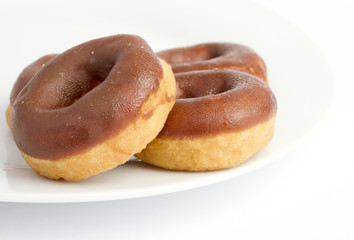 Chocolate donuts on a white plate