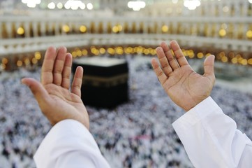 Muslim praying at Mekkah with hands up