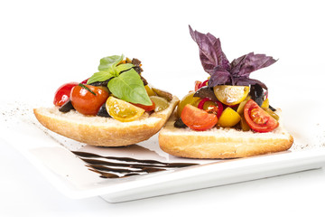 juicy tomatoes on fresh bread, pesto as topping