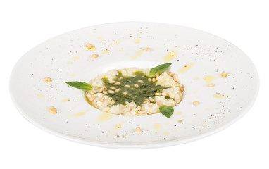 photo of delicious risotto dish with herbs and cedar nut on whit