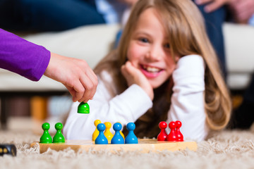 Family playing board game at home