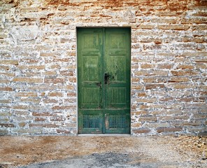 Fototapeta na wymiar green wooden door on brick wall