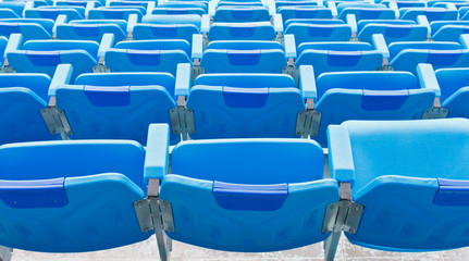 Naklejka premium Blue empty plastic seats at stadium