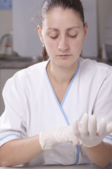 Putting examination gloves