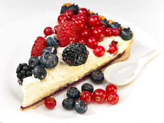 Piece of a pie with fresh berries on a plate